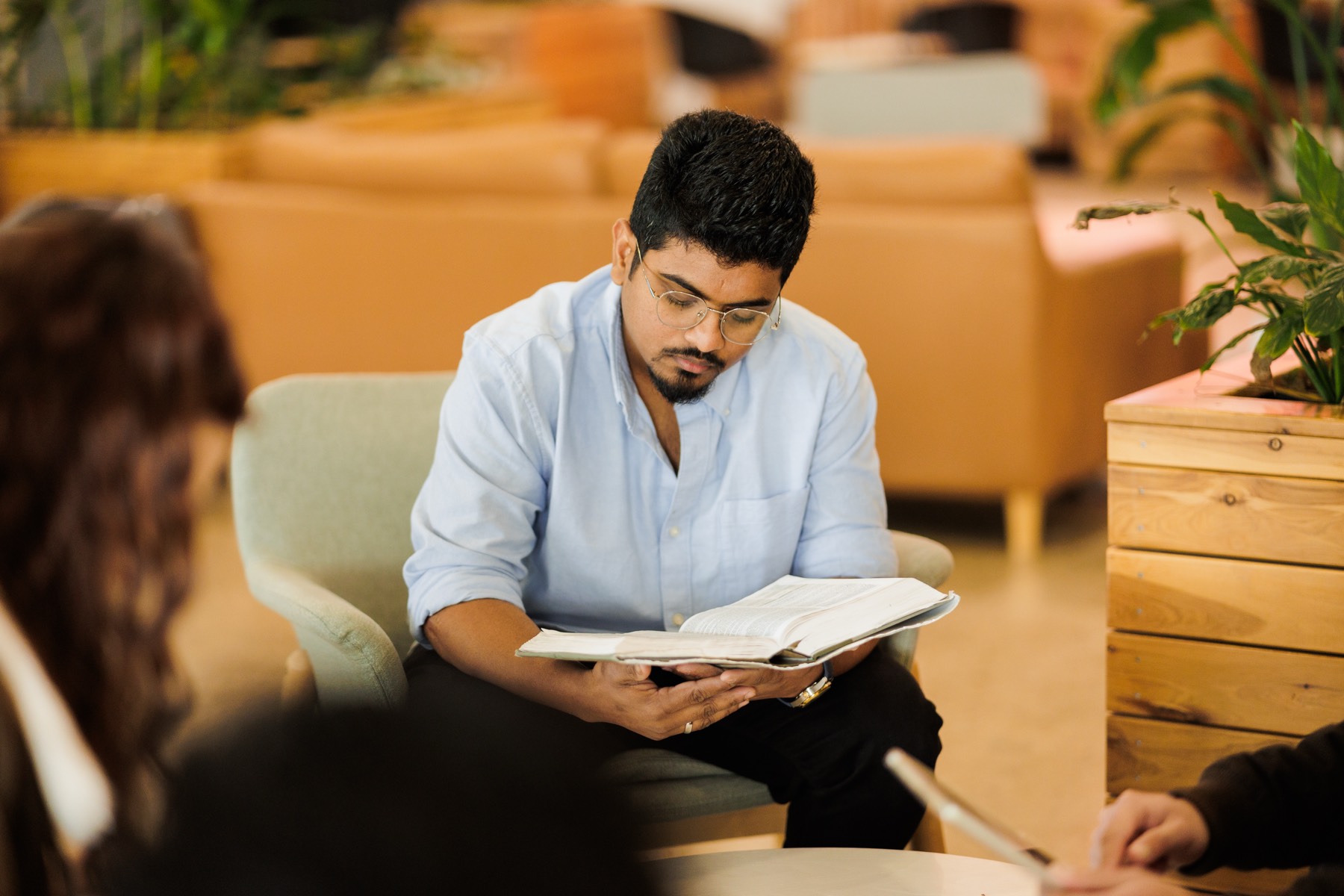 A student reading in the college common room